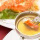 King crab dipped in the king of sauces—clarified butter. (Photo: Grandriver/Getty Images)